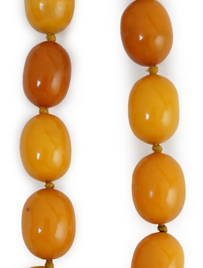 A single strand graduated oval amber bead necklace